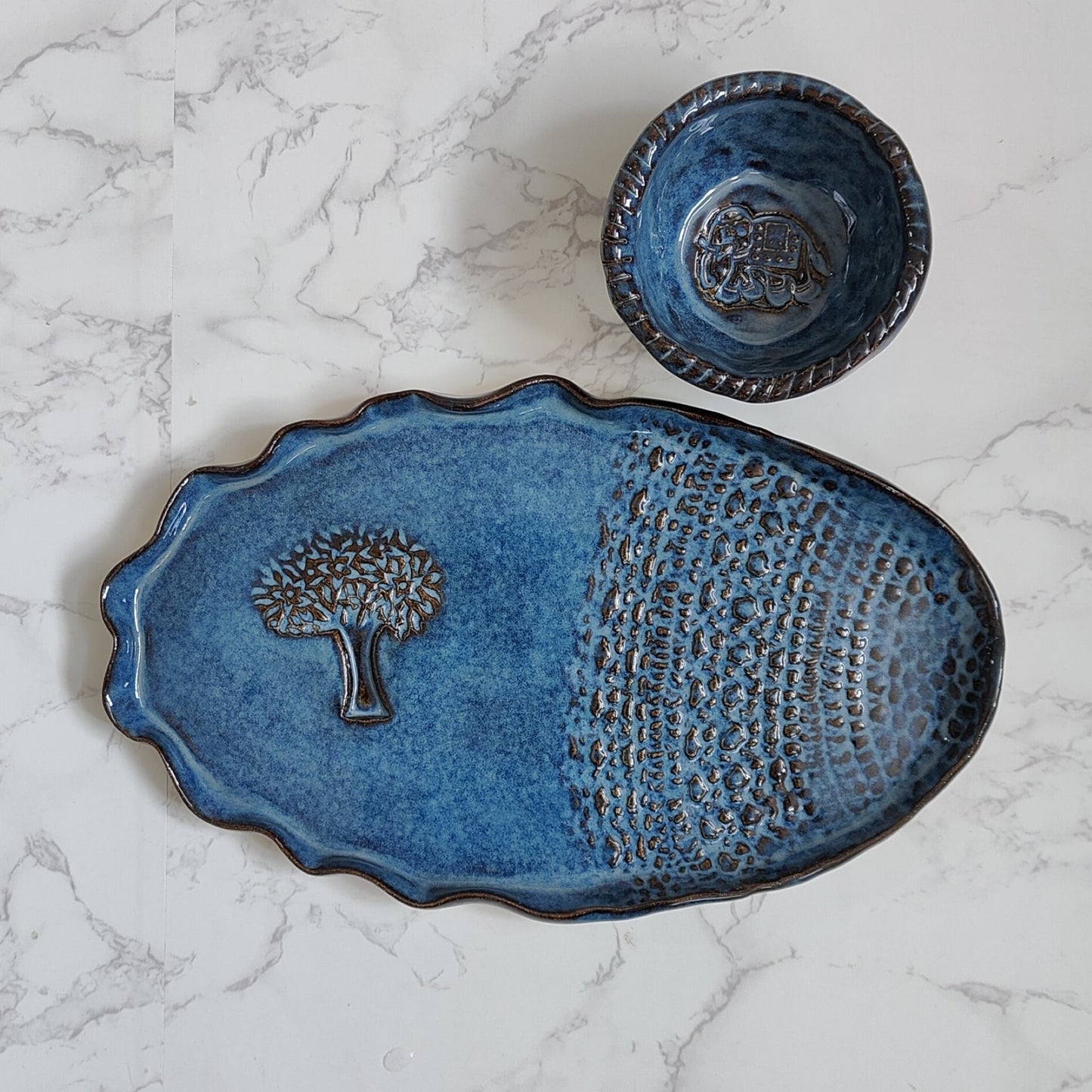 Snack platter glazed in blue color, made using slab technique of pottery hand-building