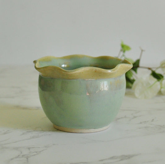 Handmade ceramic bowl with wavy rim, made in stoneware clay and glazed in Magic Mint green glaze.